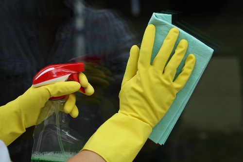Office cleaning team sanitising shared workspace in Acton