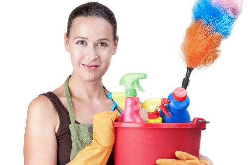 Cleaner using protective gloves and safety equipment during a cleaning task