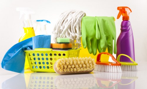 A cleaner using approved products and protective equipment safely